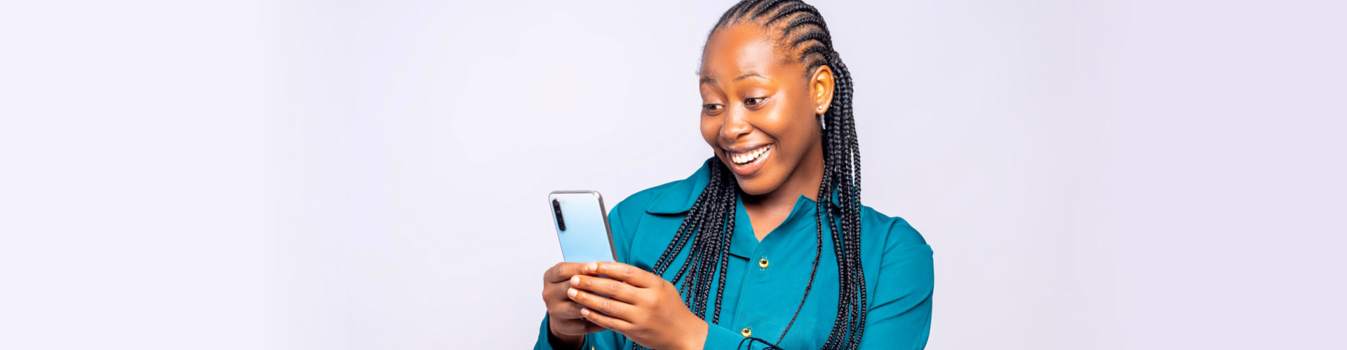 woman smiling while using her phone