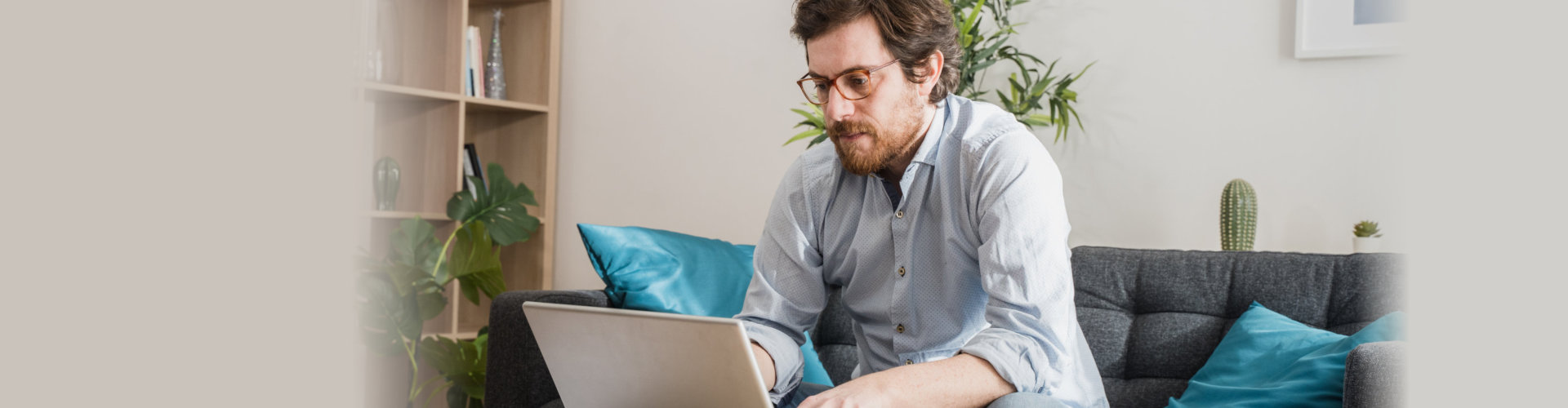 man typing with his laptop at home